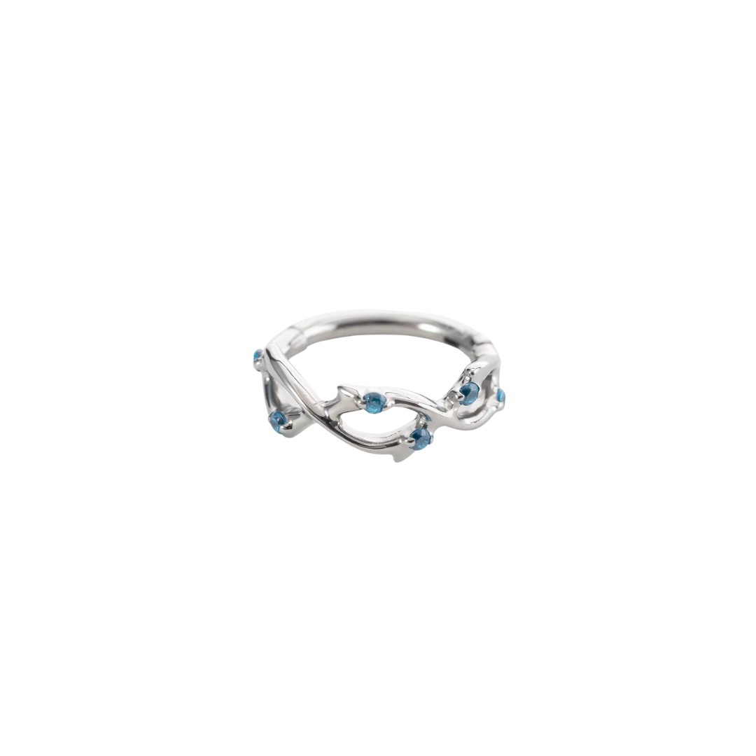 Ring with swirls and blue gems