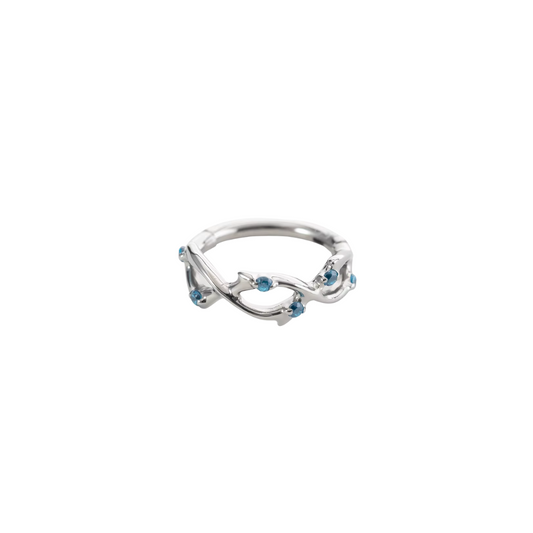 Ring with swirls and blue gems