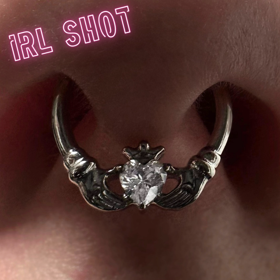 Ring with hands holding a heart